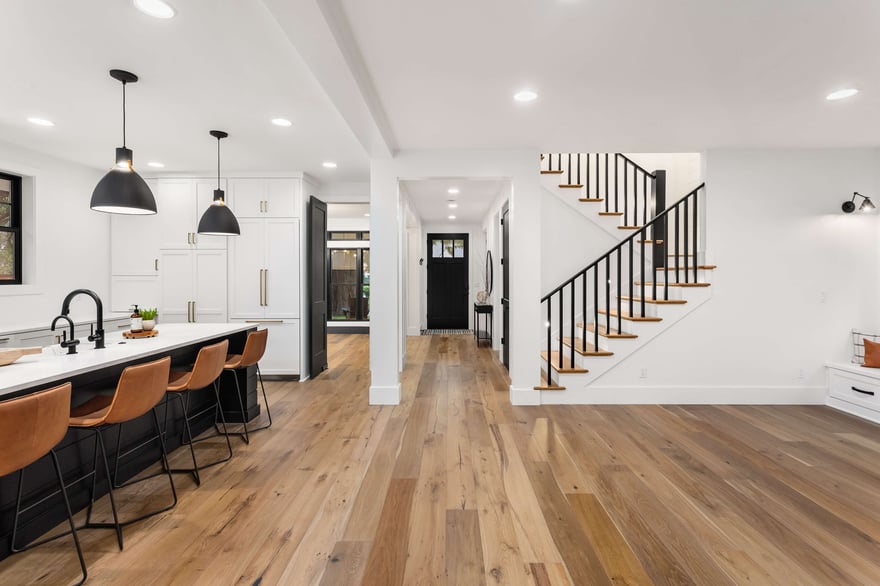 white and wood interior kitchen and living room open concept